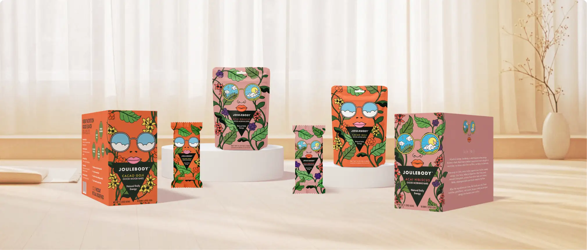 Colorful boxes with abstract face designs arranged on a wooden surface in front of a window with curtains.