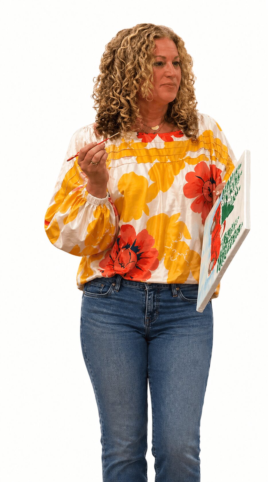 Woman with curly hair holding a book, wearing a floral blouse and jeans, looking to the side.
