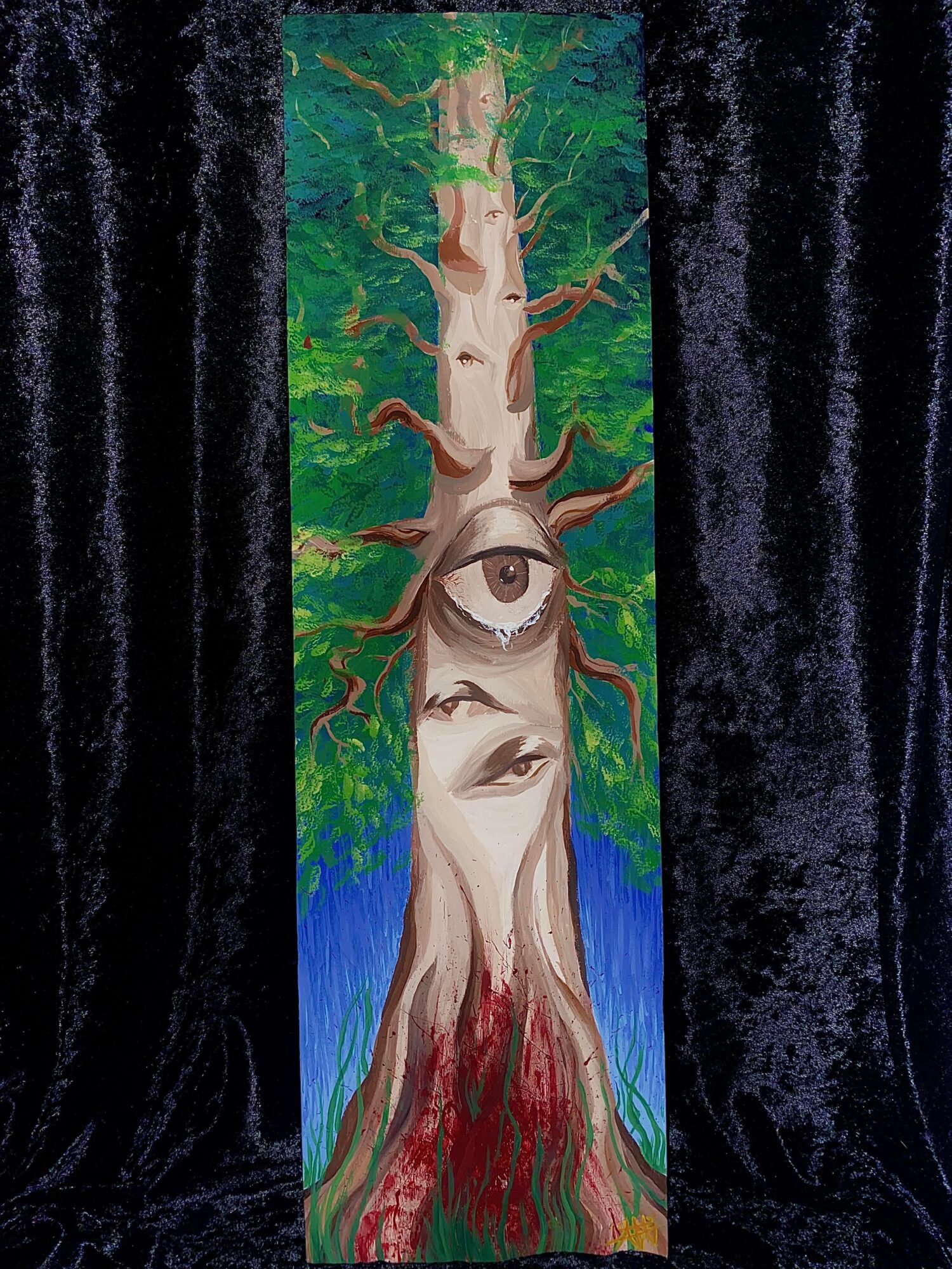 Vertical painting of a tree with an eye and a face in the trunk, surrounded by green leaves and blue background.