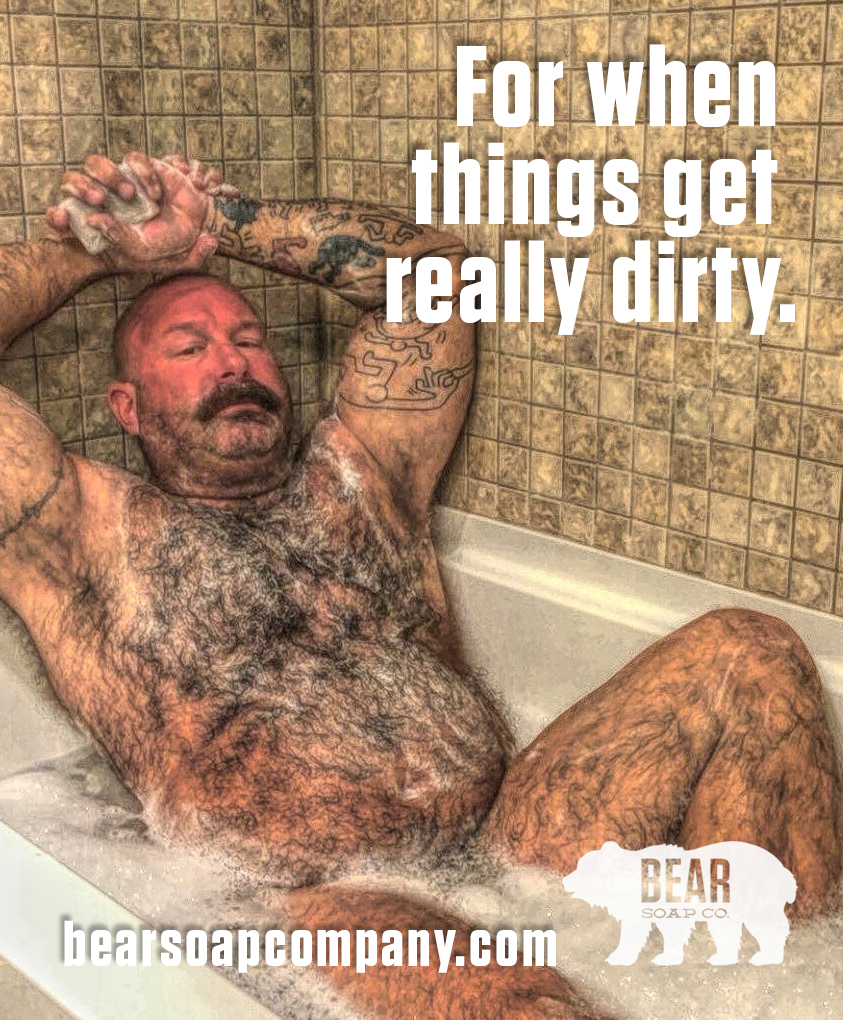 A bearded man with tattoos reclines in a bathtub with a tiled wall background, with text overlay about dirtiness.