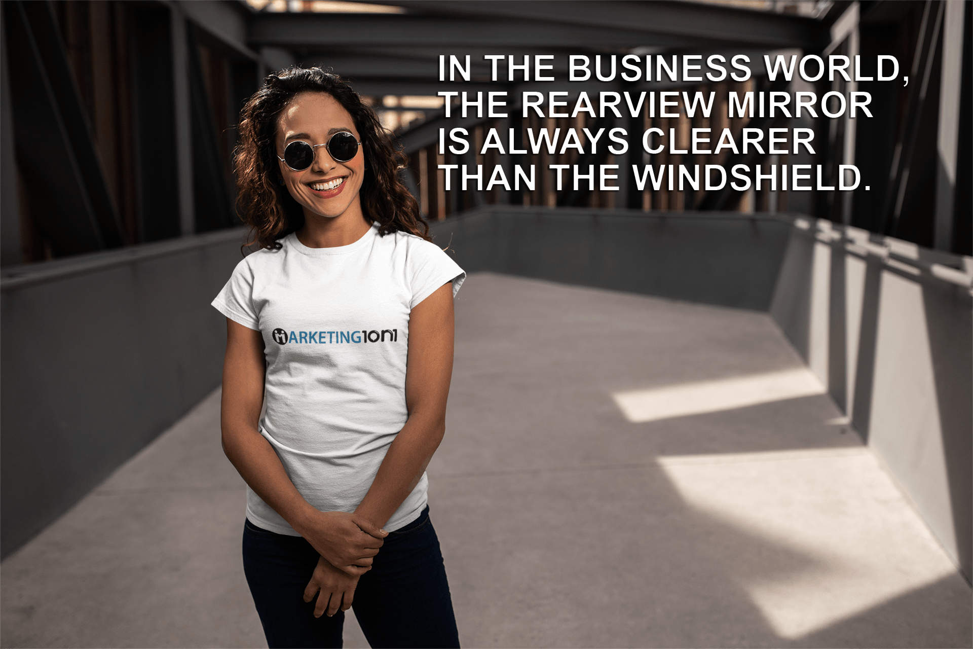 Smiling woman with sunglasses standing outdoors on a bridge, with text about business and rearview mirrors.